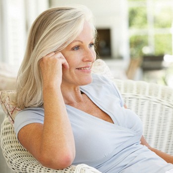 Woman sitting outdoors thinking